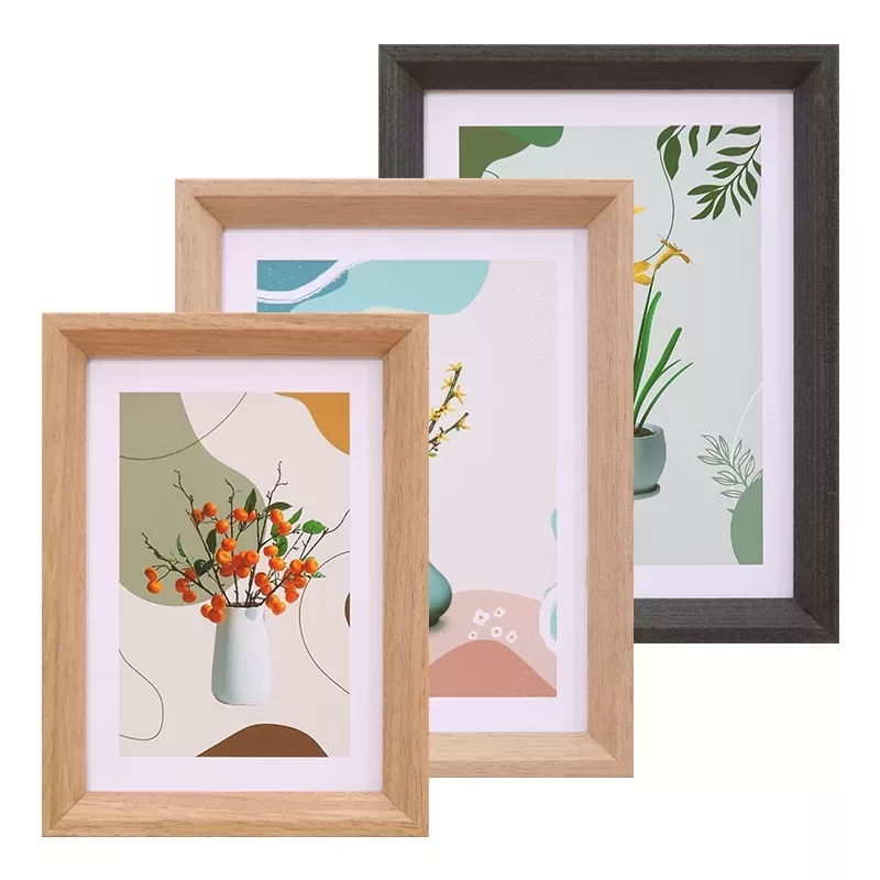 Three framed botanical art prints in wooden frames.