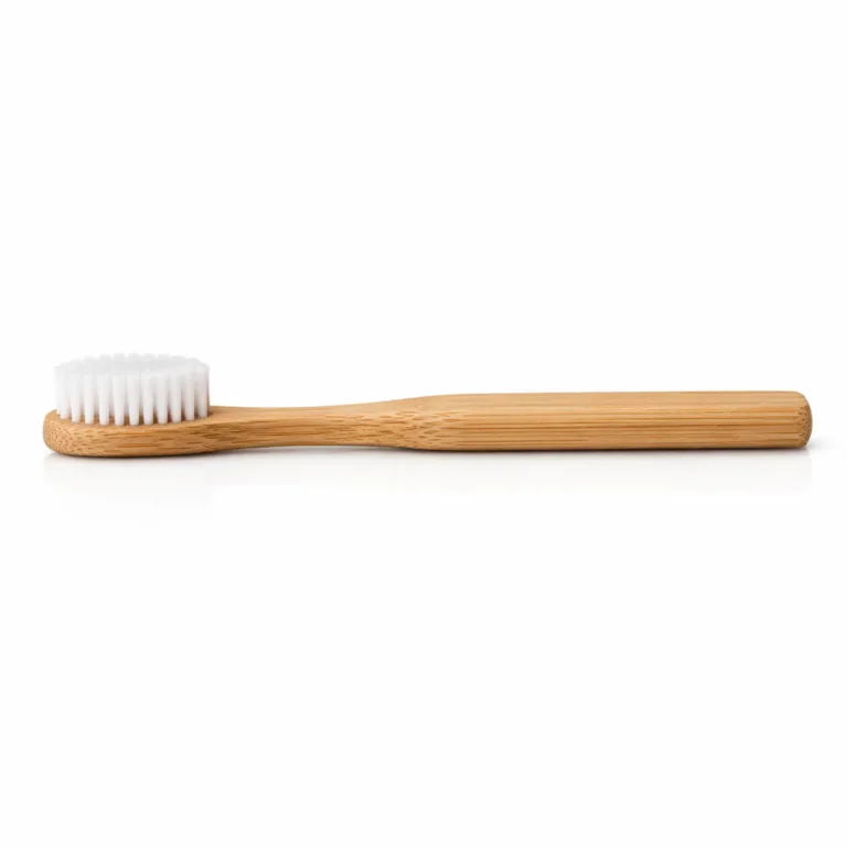 A bamboo adult soft bristle toothbrush featuring a smooth natural bamboo handle and white nylon bristles. The handle has a traditional straight shape and showcases the light, authentic bamboo grain. Ideal for eco-conscious oral care.