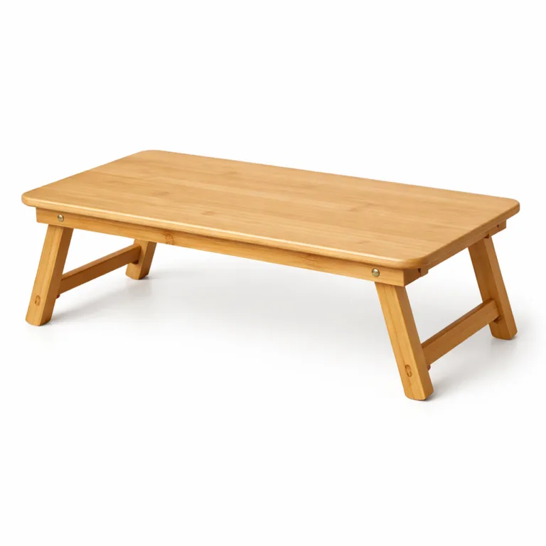 A natural finish bamboo bed laptop table with folding legs, featuring minimalist design and gently rounded edges for comfort and style. Perfect for bed or sofa use.