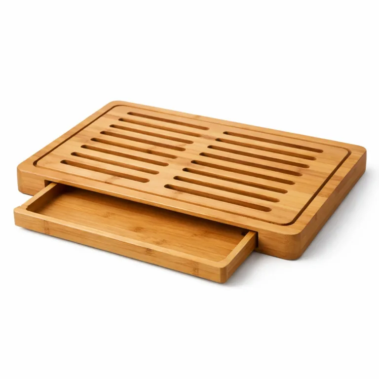 A matte-oiled bamboo bread cutting board and crumb tray, highlighting a clean perimeter groove for capturing crumbs around the edge.