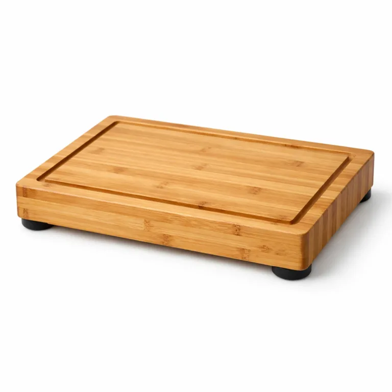 Rectangular bamboo butcher block cutting board featuring a juice groove and discrete anti-slip silicone feet on the bottom for added stability during use.