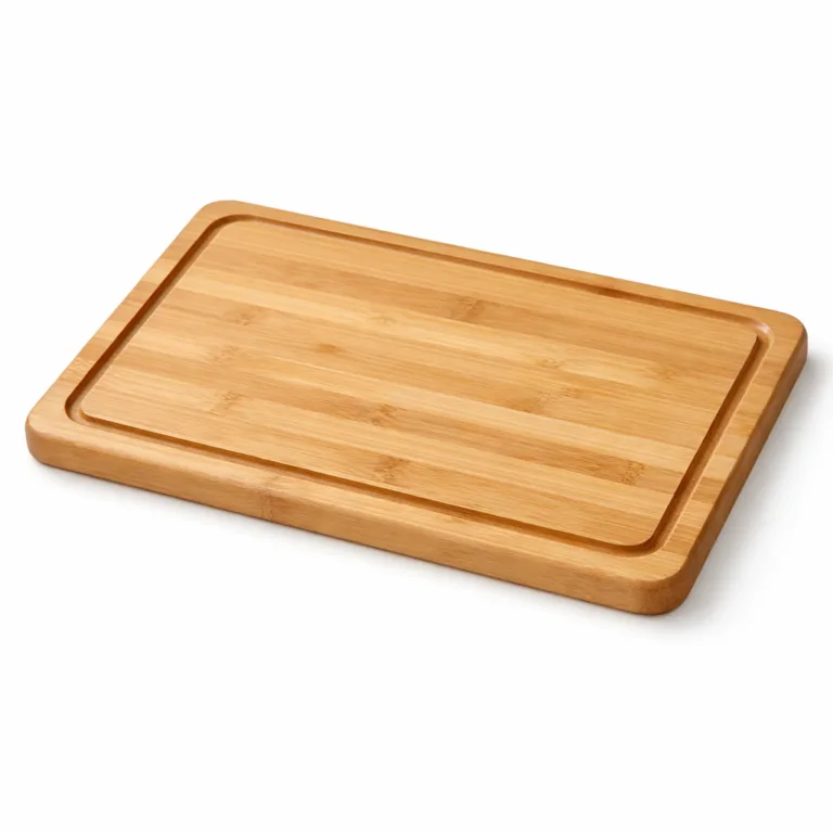 A rectangular bamboo carving board featuring a drip channel around the edge, crafted from natural bamboo and finished with softly rounded edges for a comfortable grip.