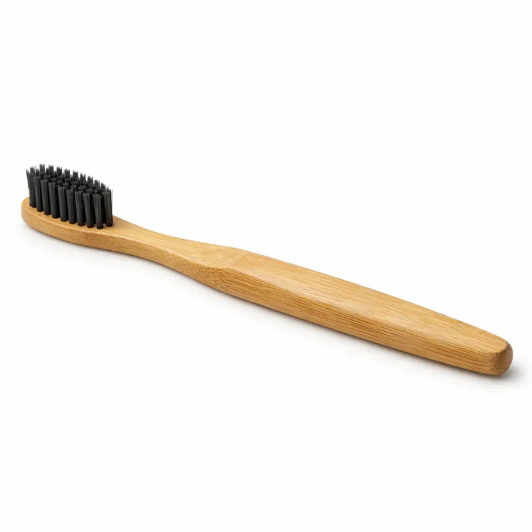 E-commerce product photo of a Bamboo Charcoal Bristle Toothbrush featuring a matte-oiled bamboo handle enhanced with a shallow groove for grip, and black charcoal-infused bristles. Designed for secure handling.