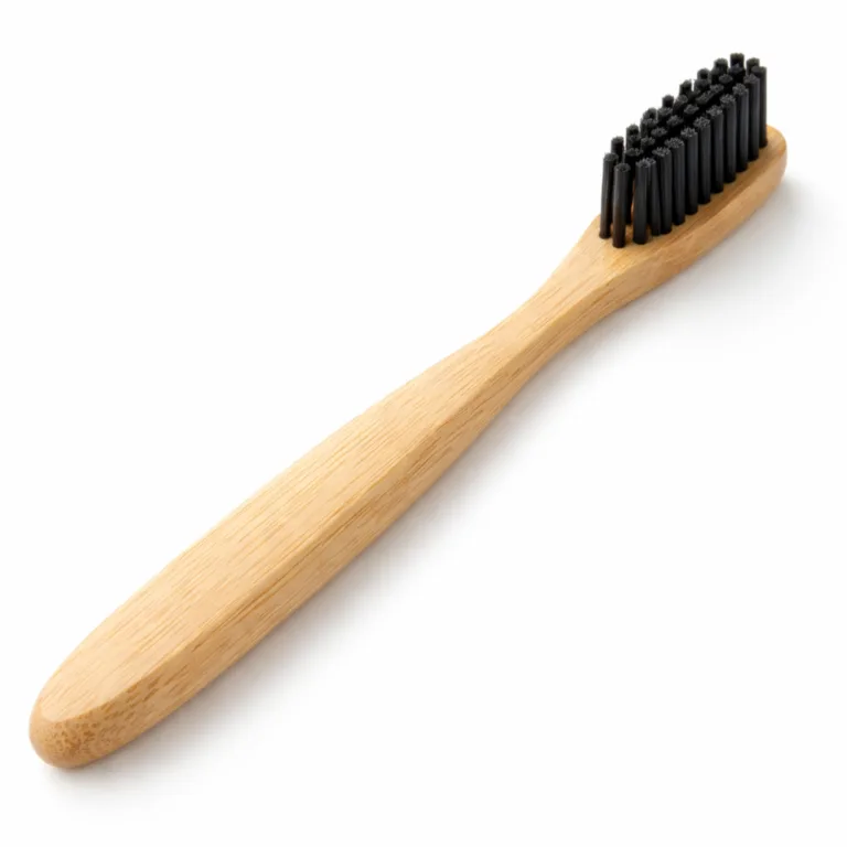 High realism studio image of a Bamboo Charcoal Bristle Toothbrush featuring a smooth, natural bamboo handle, gently rounded edges, and black charcoal-infused bristles. Ideal for eco-friendly dental care.