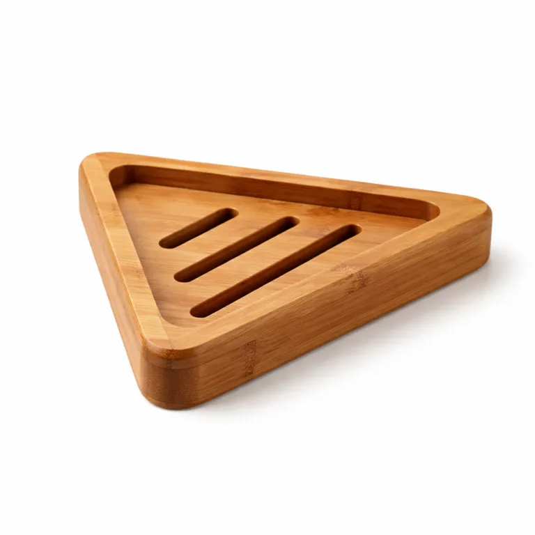 A triangular corner soap dish crafted from carbonized bamboo, featuring a naturally darkened finish, beveled edges, and a wide central groove for water drainage.