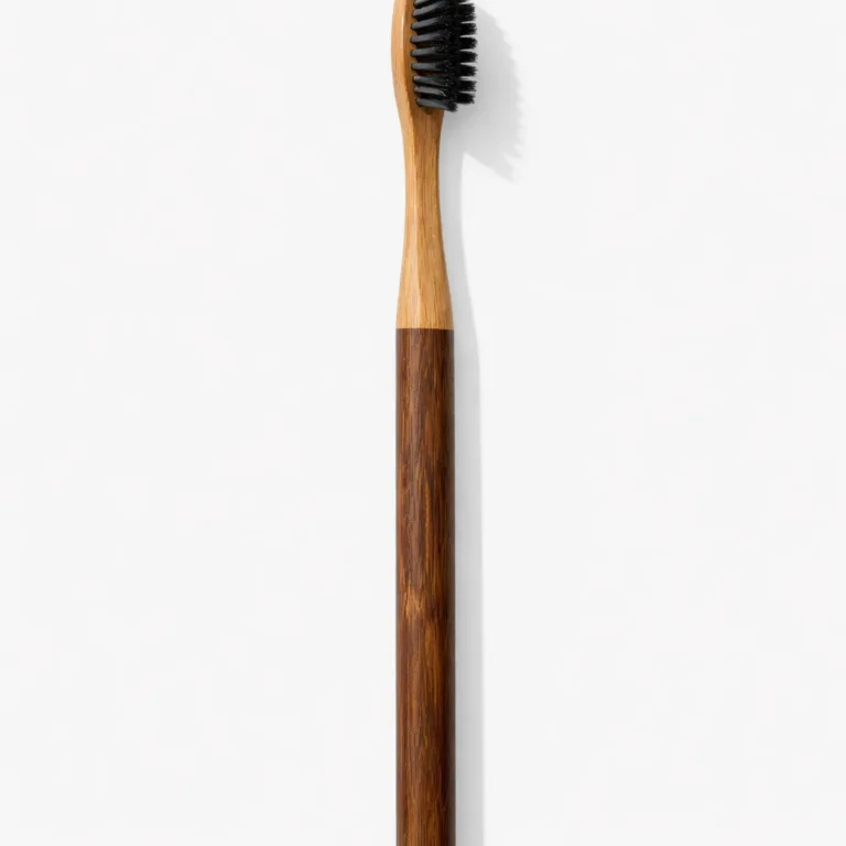 A commercial-grade image of the Bamboo Eco Starter Kit Toothbrush with carbonized bamboo, featuring a rich dark finish. The classic straight handle provides a modern touch, highlighting the deep color and smooth texture of carbonized bamboo.