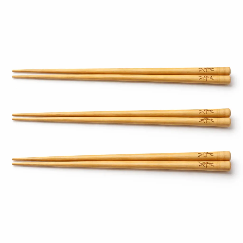A classic pair of bamboo chopsticks featuring a natural finish and subtle logo engraving positioned near the handle. The chopsticks have a standard form with rounded tips, perfect for everyday dining and showcasing eco-friendly craftsmanship.