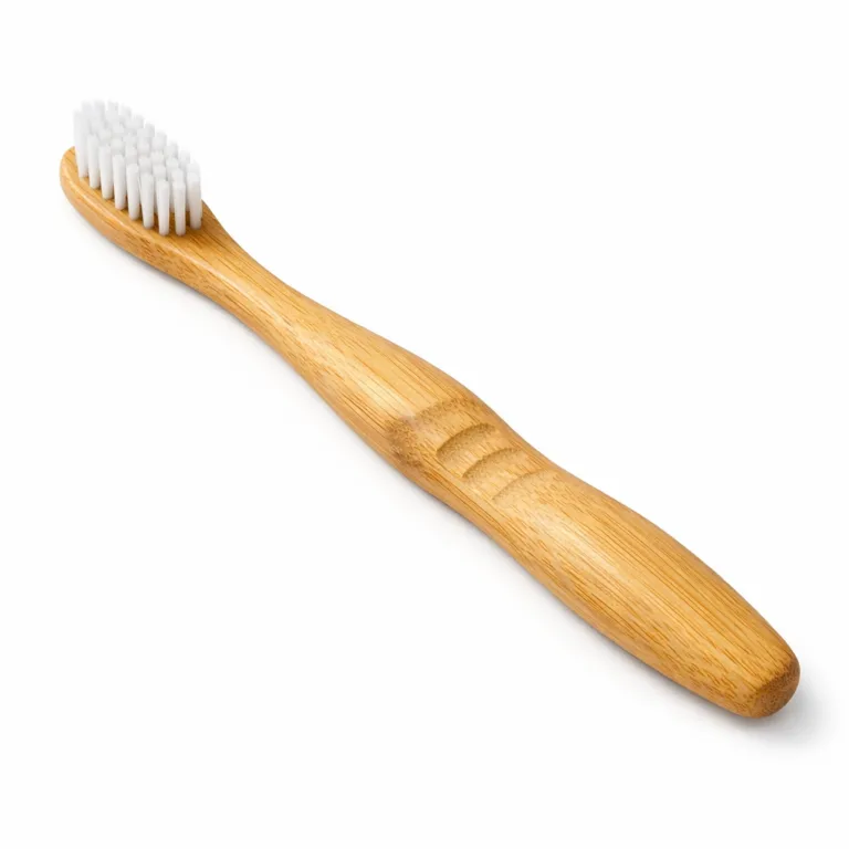 A Bamboo Ergonomic Handle Toothbrush with a matte-oiled bamboo finish and an integrated anti-slip groove running along the handle for improved grip, combining functionality and natural aesthetics.