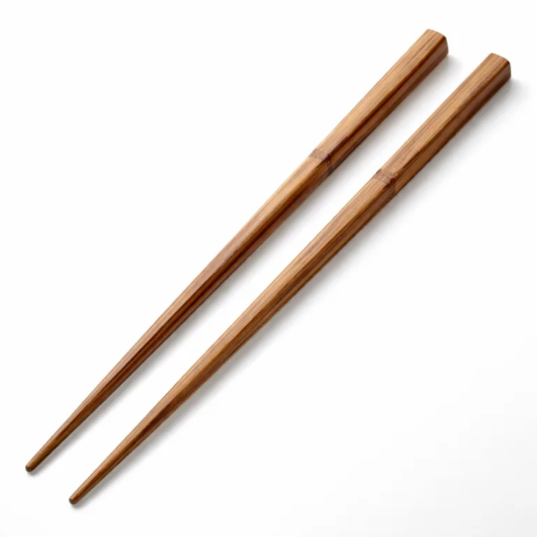 Pair of heat-resistant bamboo cooking chopsticks in a carbonized finish, designed with square handles for enhanced grip. The rich, darkened bamboo surface adds a sophisticated touch to kitchen utensils.