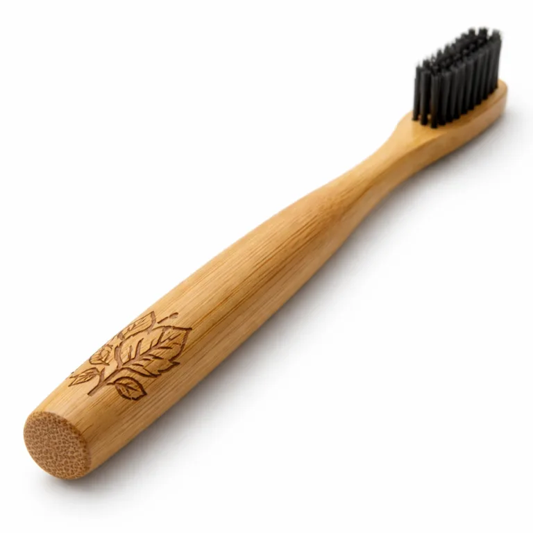 A stylish toothbrush made from carbonized bamboo, featuring a deep brown tone, round handle, and laser-engraved logo positioned near the base. Photographed in sharp detail for e-commerce presentation.