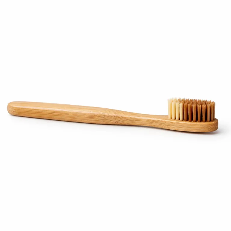 A bamboo medium bristle toothbrush featuring a classic straight handle with a matte-oiled finish. The surface displays a gentle sheen and pronounced wood grain, perfect for modern eco-friendly personal care.