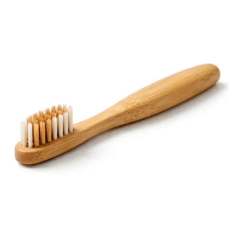 A natural bamboo toothbrush with medium bristles, designed with smoothly rounded edges on the handle to enhance user comfort while brushing.