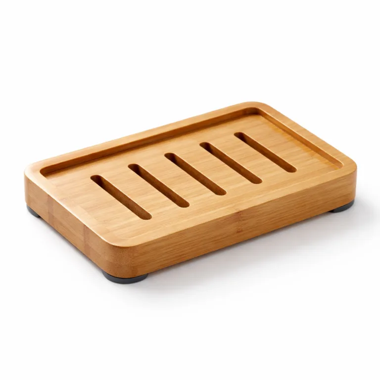 Sleek, polished bamboo soap holder with a minimalist slotted pattern and four discrete rubber anti-slip feet on the base to prevent sliding, ensuring stability on any countertop.