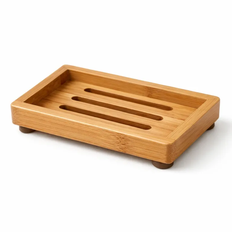 This bamboo rectangular soap plate features a slotted surface for drainage, a raised rim to contain soap securely, and discreet anti-slip feet ensuring stability on wet counters.