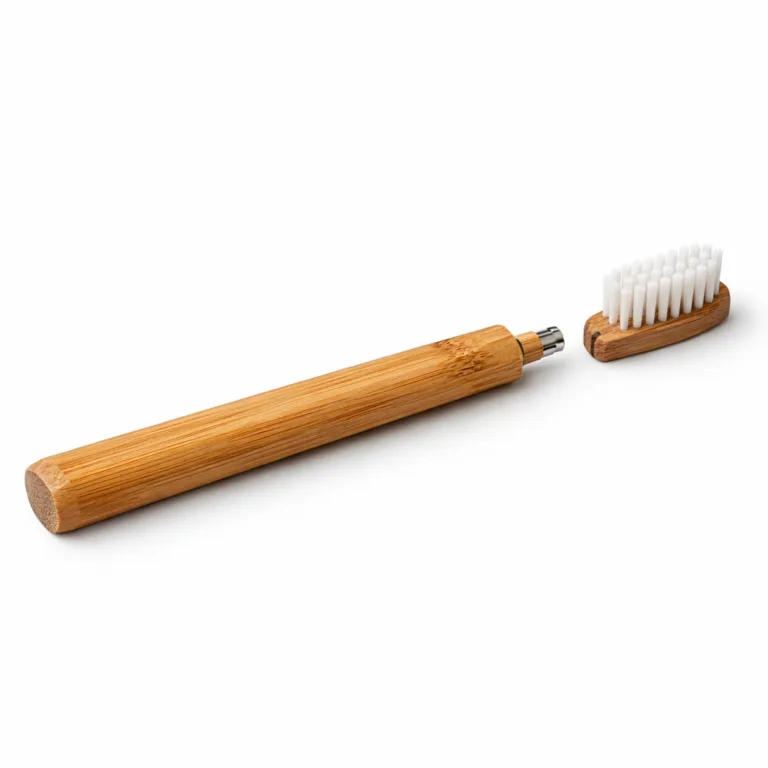 A single Bamboo Replaceable Head Toothbrush made from carbonized bamboo for a darker, richer finish. This variant features distinctive beveled edges along the handle and an ergonomic shape. The head is equipped with soft bristles and a secure replaceable design. Photographed in high realism with commercial lighting against a white background.