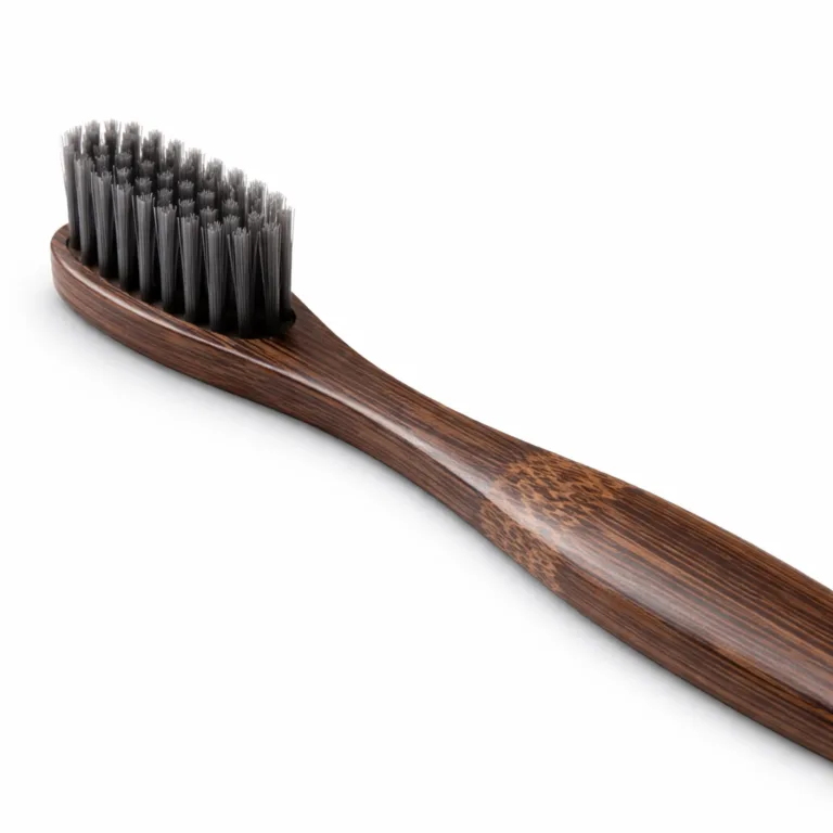 A Bamboo Sensitive Gum Toothbrush with a carbonized Moso bamboo handle, showcasing a rich dark finish and ultra-soft bristles for sensitive gums. Captured in studio style with crisp detail and a minimalist white background.