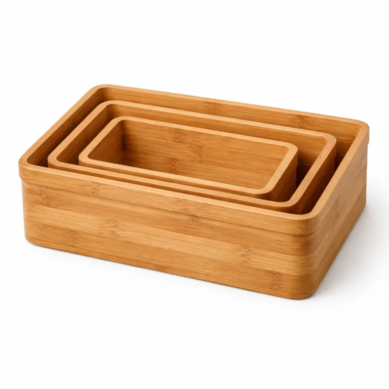 Set of three rectangular bamboo shelf baskets, matte-oiled finish for a contemporary look and soft tactile feel. All baskets nested together, studio-lit upon a seamless white background.