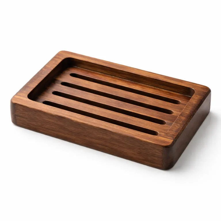 A rectangular slatted soap dish made from carbonized bamboo with a rich dark brown finish and tastefully beveled outer edge. Crafted for enhanced durability and elegant bathroom organization.