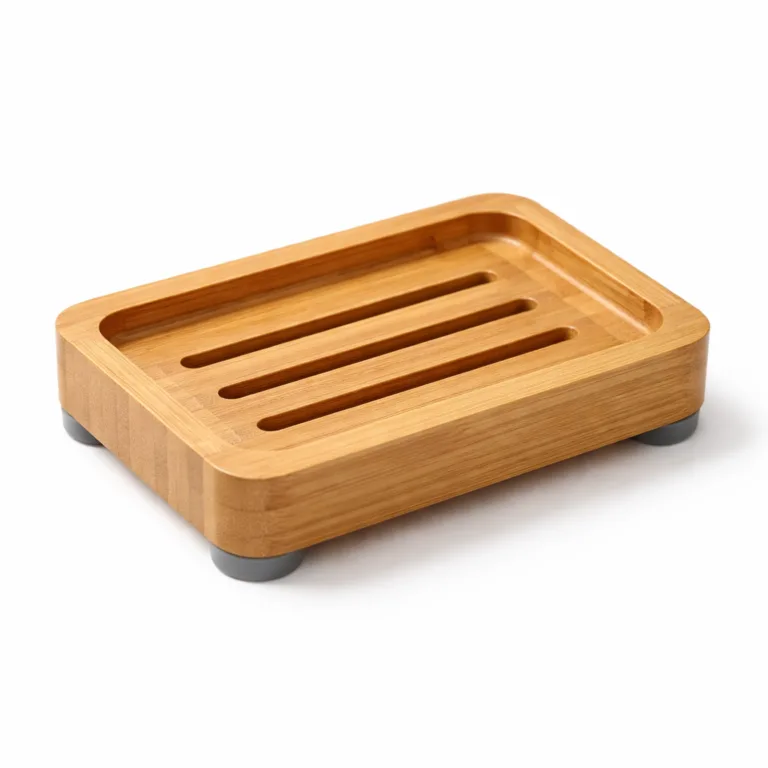 This rectangular bamboo soap dish is finished in a smooth matte oil, providing a subtle sheen and moisture resistance. It features slots for drainage, visible silicone feet for grip, and an additional groove along the rim to guide excess water away and keep surfaces dry.
