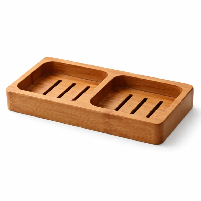 A double soap holder in carbonized bamboo featuring two polished compartments, each equipped with drainage slots for improved airflow and quicker soap drying.