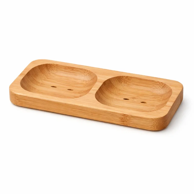 A natural bamboo double soap holder featuring two rectangular compartments and rounded edges. The unfinished surface highlights the authentic bamboo grain, ideal for a minimalist bathroom setting.
