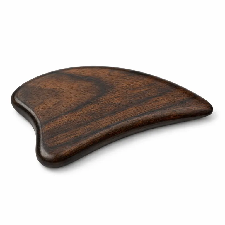 Studio image of a wing-shaped wooden gua sha massager, crafted from carbonized beech wood for a distinctive dark appearance, featuring beveled edges for enhanced grip and maneuverability. Ideal for professional product listings.