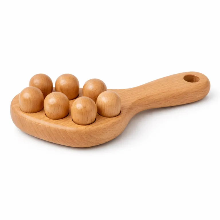 A beech wood lymphatic massage tool with a matte-oiled finish, ergonomic handle, and a practical hanging hole for easy storage, captured as a detailed studio product photography.