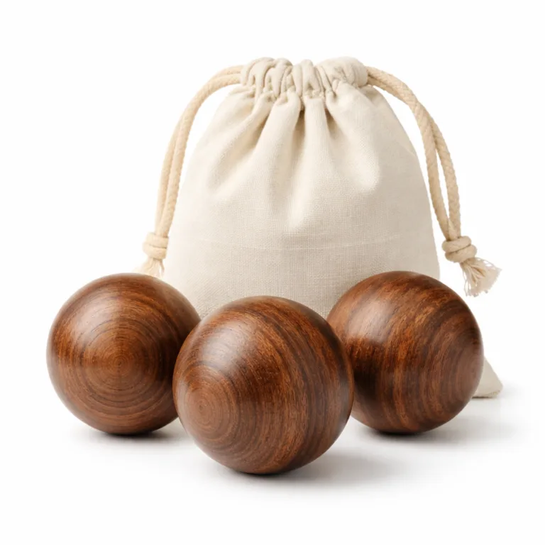 Three acacia wooden massage balls with a luxurious carbonized finish for a deep, rich wood color. Set is paired with a cotton pouch, ideal for stylish therapeutic use.