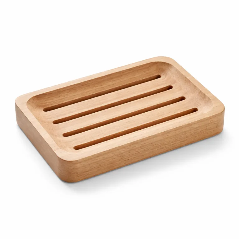 A natural beech wood self-draining soap tray, featuring a finely sanded smooth finish and subtle, softly rounded corners for a gentle aesthetic. Designed with parallel drainage cutouts to keep soap dry and prolong its use. Photographed in a commercial studio with a pure white background, perfect for e-commerce display.