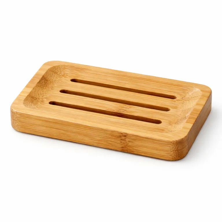 A natural bamboo soap dish for shampoo bars, featuring a rectangular form with neatly slotted drainage grooves and smoothly rounded edges. Ideal for modern bathrooms, shown in clear commercial lighting.