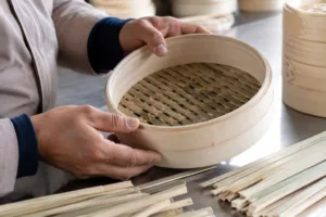 A detailed product image focused on bamboo strip consistency, weaving quality, and rim integrity during inspection.