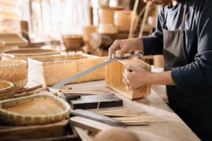A warm workshop scene showing hands-on bamboo basket production for custom brand orders.